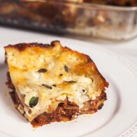 A feta bechamel, ground lamb, as el hangout, and dried apricots make this lasagna recipe extra special! | www.spachethespatula.com