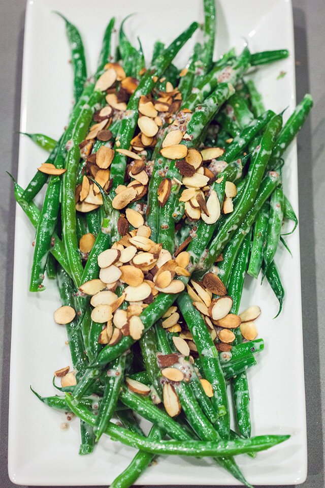 Crisp green beans are coated with a creamy, herby, whole grain mustard sauce, and topped with crunchy toasted almonds, and ready in 5 minutes! | www.spachethespatula.com #recipe