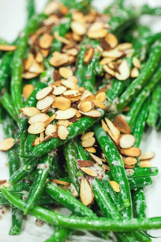 Crisp green beans are coated with a creamy, herby, whole grain mustard sauce, and topped with crunchy toasted almonds, and ready in 5 minutes! | www.spachethespatula.com #recipe