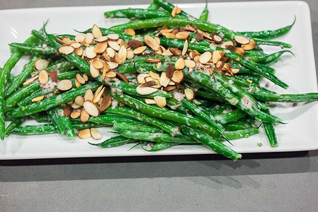 Crisp green beans are coated with a creamy, herby, whole grain mustard sauce, and topped with crunchy toasted almonds, and ready in 5 minutes! | www.spachethespatula.com #recipe