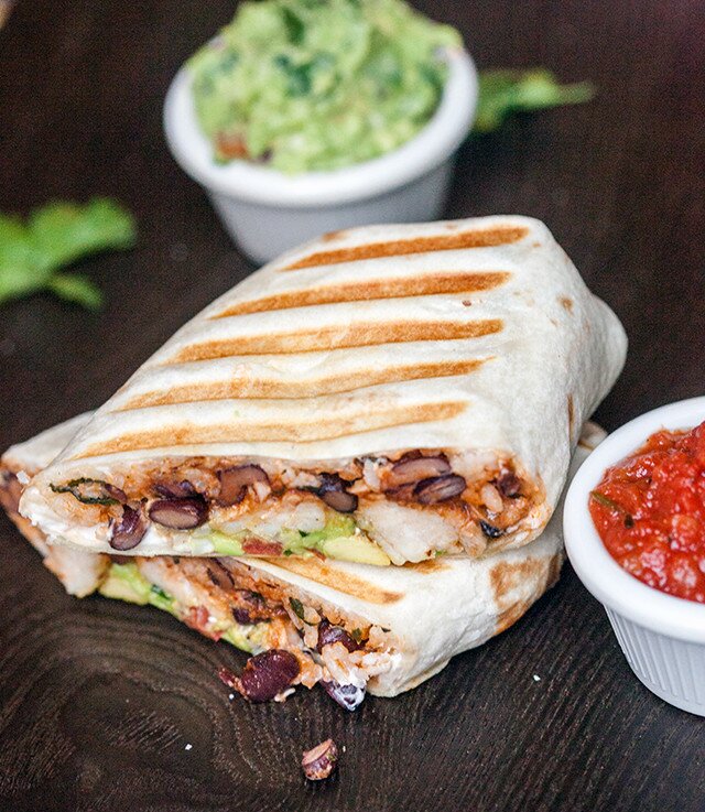 You can use any white fish in these flavorful, simple burritos, packed with cilantro-lime rice, and black beans cooked in tomato juice! | www.spachethespatula.com #recipe