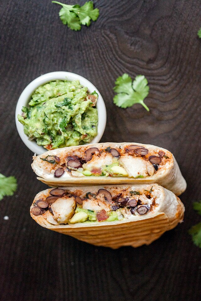 You can use any white fish in these flavorful, simple burritos, packed with cilantro-lime rice, and black beans cooked in tomato juice! | www.spachethespatula.com #recipe