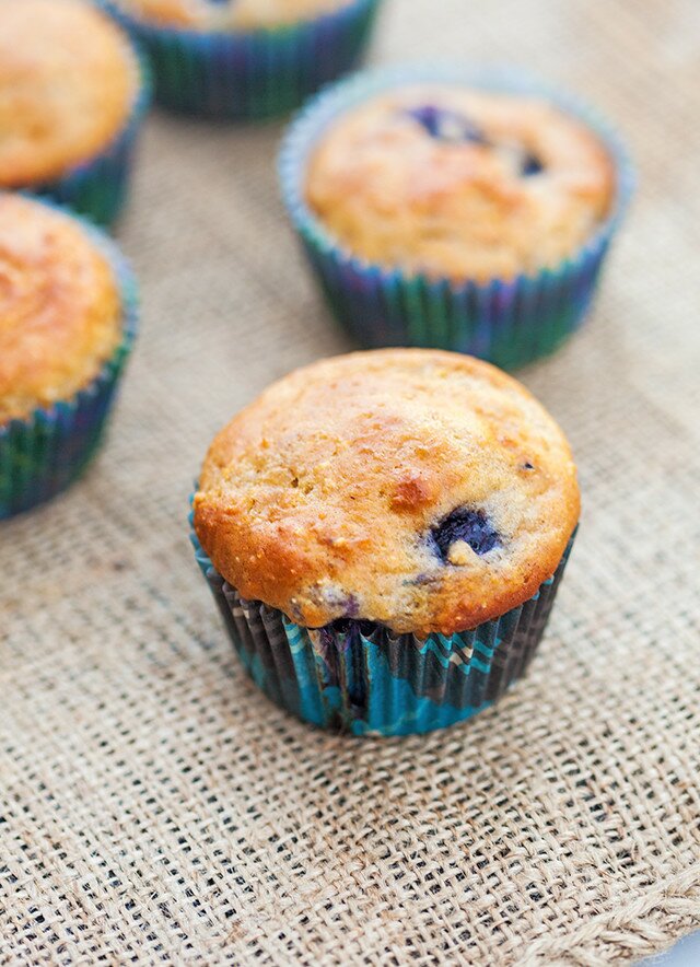 You choose---Whole grain and refined sugar-free? or a more standard AP flour and sugar version! Both contain tons of blueberries and are less than 100 calories each! | www.spachethespatula.com #recipe