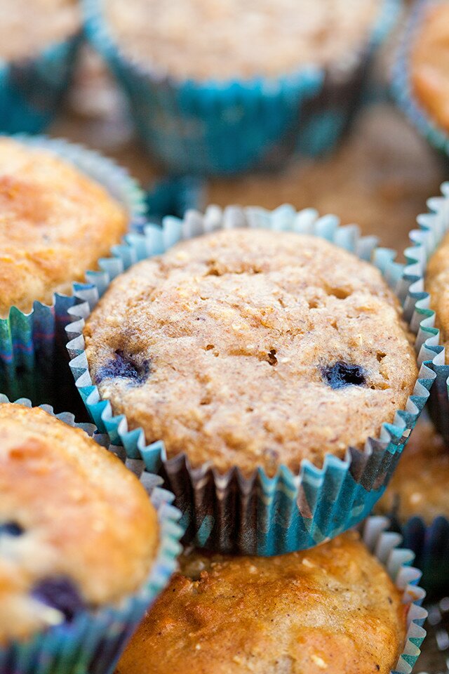 You choose---Whole grain and refined sugar-free? or a more standard AP flour and sugar version! Both contain tons of blueberries and are less than 100 calories each! | www.spachethespatula.com #recipe