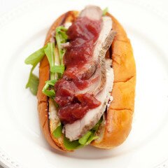 Super moist and flavorful pork loin, spicy arugula, and a homemade cherry sauce all stuffed in a Hawaiian bun! | www.spachethespatula.com #recipe