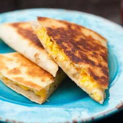 Creamy, cheesy scrambled eggs stuffed inside a crisp, golden brown tortilla! | www.spachethespatula.com #recipe