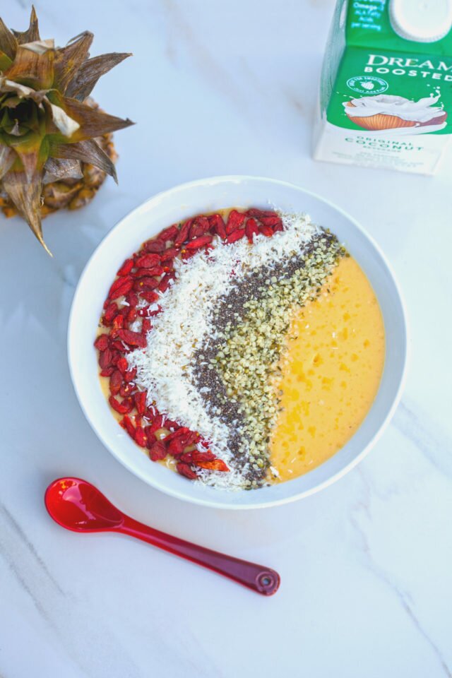 Tropical fruit and a nutrient-dense base make up this gorgeous smoothie bowl! #RootedinNutrition | www.spachethespatula.com #recipe #vegan