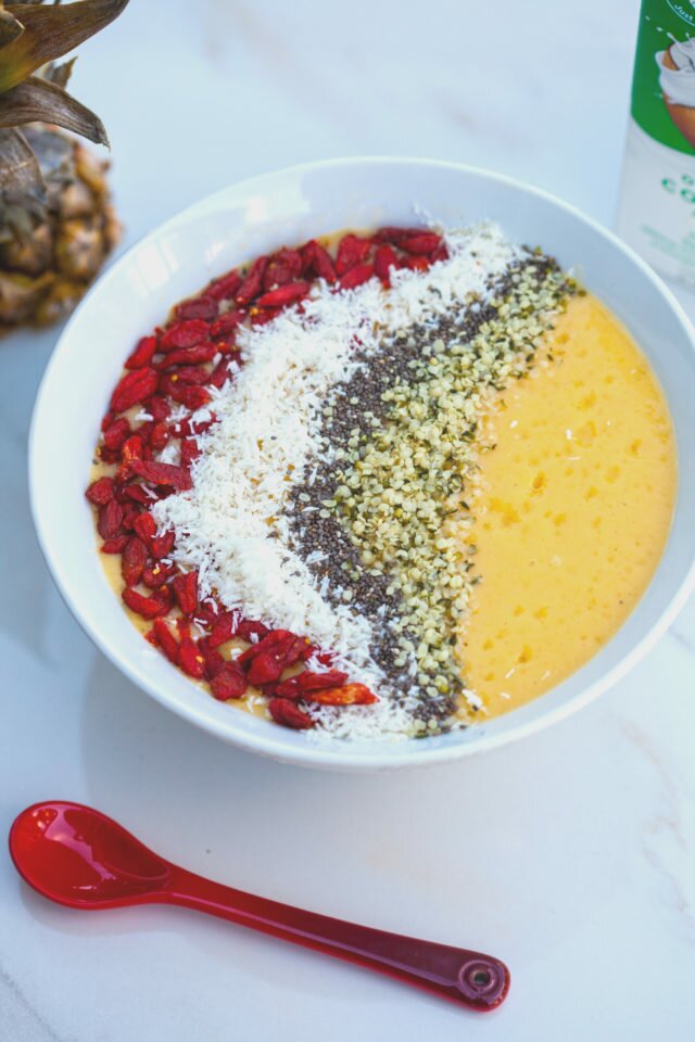 Tropical fruit and a nutrient-dense base make up this gorgeous smoothie bowl! #RootedinNutrition | www.spachethespatula.com #recipe #vegan