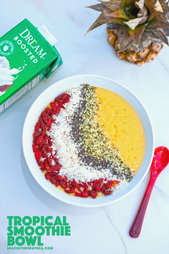 Tropical fruit and a nutrient-dense base make up this gorgeous smoothie bowl! #RootedinNutrition | www.spachethespatula.com #recipe #vegan