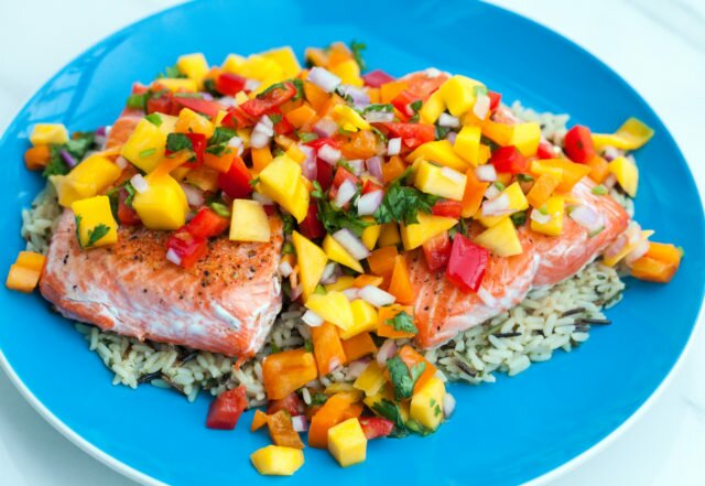 A fresh and vibrant mango salsa tops seared salmon fillets in the perfect Summer dish! | www.spachethespatula.com #recipe