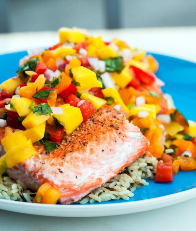 A fresh and vibrant mango salsa tops seared salmon fillets in the perfect Summer dish! | www.spachethespatula.com #recipe