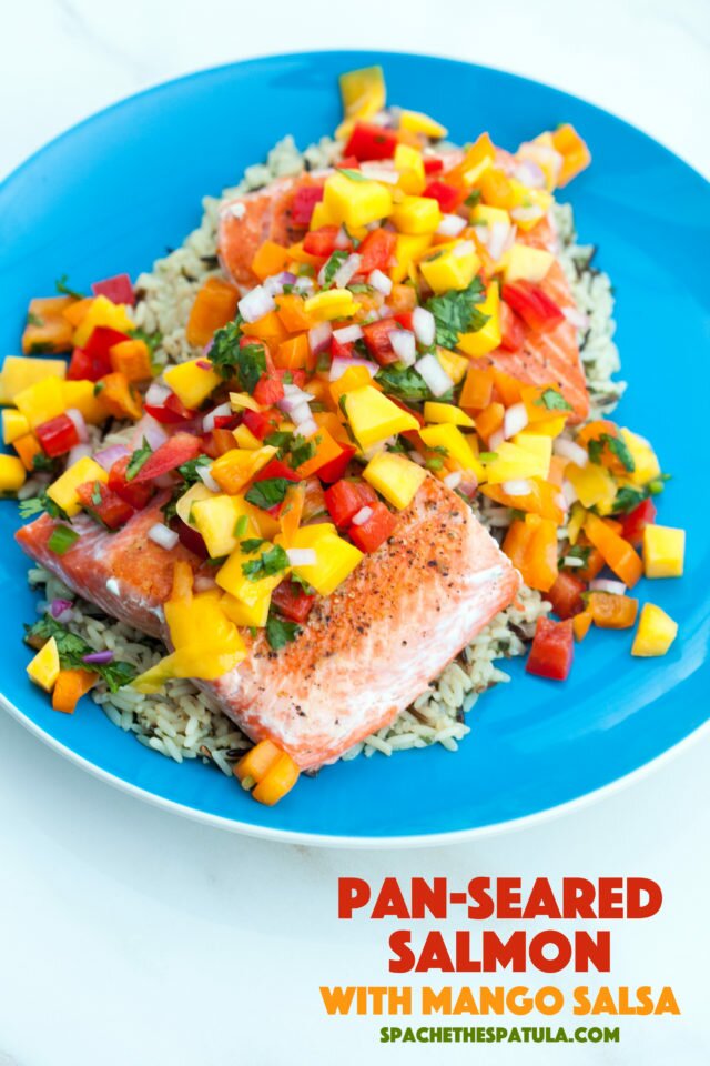 A fresh and vibrant mango salsa tops seared salmon fillets in the perfect Summer dish! | www.spachethespatula.com #recipe